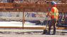  Crews pour concrete for the final deck section of the Bay Bridge