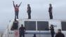 Man gets on top of train at BART station in Oakland (Courtesy of Dave Byers of the  San Francisco Chronicle )