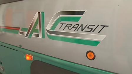 The AC Transit logo on the side of a bus.