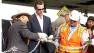  Lt. Governor Gavin Newsom cuts the ceremonial chain with a blow torch to mark the opening of the Bay Bridge.