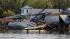 A shrimp boat is bashed against the dock of...