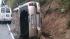 Dealing with the aftermath of the storm :: A mini-van on its side
