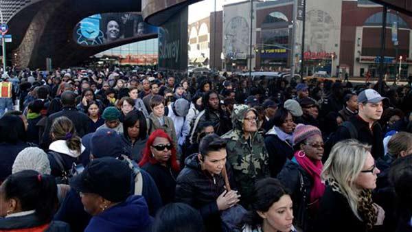 Commuters wait in a line to board buses into Manhattan in front of the Barclays Center in Brooklyn, New York, Thursday, Nov. 1, 2012.