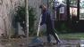 Woman cleans up after minor flooding from the Russian River
