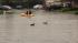 People raft down a street in East Vallejo after...