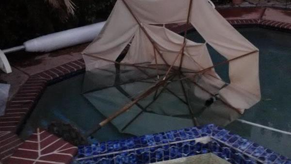 High winds swept patio furniture into a swimming pool in San Jose