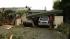 Storm-toppled tree crushes carport and cars in...
