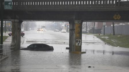 An abandoned car bobs in standing water under an overpass Thursday, April 18, 2013, in Chicago.