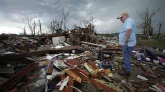 Monty Montgomery surveys the scene as he prepares to clean up a friends tornado-ravaged home Thursday, May 23, 2013, in Moore, Okla.
