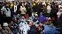 People gather and wait on the National Mall in...