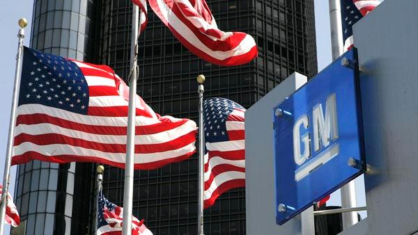 U.S. flags are shown outside of General Motors world headquarters in a Detroit file photo from April 18, 2006. (AP Photo/Paul Sancya, File)