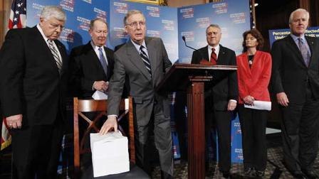 Senate Minority Leader Sen. Mitch McConnell of Ky., center, shows copy of the Democratic health care reform bill during a news conference on Capitol Hill in Washington, Friday, Nov. 20, 2009. From left are, Sen. Mike Enzi, R-Wyo., Sen. Lamar Alexander, R-Tenn., McConnell, Senate Minority Whip Jon Kyl of Ariz., Sen. Lisa Murkowski, R-Alaska, and Sen. John Cornyn, R-Texas. (AP Photo/Manuel Balce Ceneta)