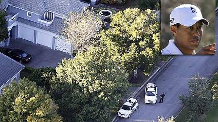 Security guards gather near Tiger Woods home, left, in Windemere, Fla., Friday, Nov. 27, 2009. Woods sustained facial cuts in a minor car accident early Friday when his SUV hit a fire hydrant and a neighbors tree as he was leaving his mansion in a gated waterfront community near Orlando, Fla. (AP Photo/Gourav Mukherjee)