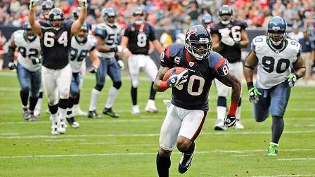 Houston Texans wide receiver Andre Johnson (80) runs up the middle to score his second touchdown of the game as Kasey Studdard (64) signals the score and Seattle Seahawks defensive tackle Colin Cole (90) follows during the second quarter of an NFL football game Sunday, Dec. 13, 2009, in Houston. (AP Photo/Dave Einsel)