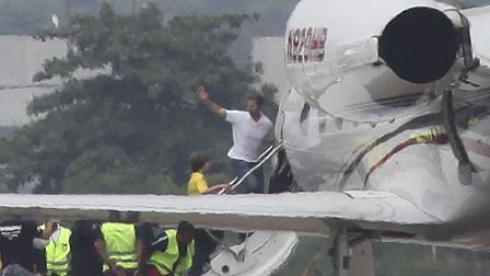 U.S. David Goldman, top, followed by his 9-year-old son Sean, waves as he boards a plane at the Galeao airport, in Rio de Janeiro, Brazil, Thursday, Dec. 24, 2009. Brazilian relatives handed the boy over to his father after Brazils Supreme Court ordered it this week after five years of court rulings and appeals over the custody of the child. (AP Photo/Silvia Izquierdo)