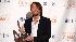 Keith Urban poses backstage with the award for...