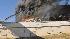 Neighbors speak on plane crash suspect :: In this photo provided by Trey Jones, smoke billows from a seven-story building in Austin, Texas after a small private plane crashed into it Thursday Feb. 18, 2010. (AP Photo/Trey Jones)