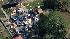 Residents can be seen sifting through debris in...