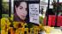 Cards and flowers are left in front of Michael...