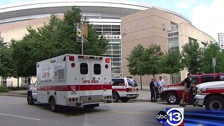 A car fire filled a Toyota Center parking garage with smoke, injuring two security guards.