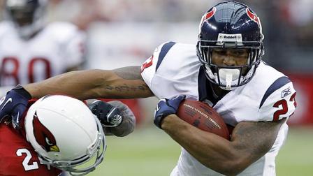 Houston Texans runningback Arian Foster (23) slips past Arizona Cardinals Adrian Wilson during the first quarter of an NFL preseason football game Saturday, Aug. 14, 2010 in Glendale, Ariz. (AP Photo/Rick Scuteri)
