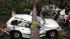 Residents in the Park Slope neighborhood in the Brooklyn borough of New York circle around a car crushed by a fallen tree, Thursday, Sept. 16, 2010. A brief but severe storm has swept through New York City, uprooting trees and damaging cars. (AP Photo/Mark Lennihan)