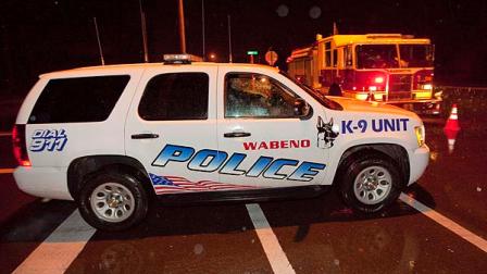 A K-9 unit drives past a roadblock near Marinette High School Monday night Nov. 29, 2010 in Marinette, Wis. during a hostage situation. A student armed with a handgun burst into a Wisconsin high school classroom at the end of the school day and held nearly two dozen students and a teacher hostage for more than five hours Monday, authorities said. (AP Photo/Mike Roemer)