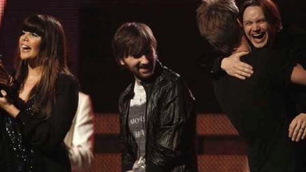 From left, Hillary Scott, Dave Haywood and Charles Kelley of Lady Antebellum are joined onstage by Josh Kear to accept the award for best country album at the 53rd annual Grammy Awards on Sunday, Feb. 13, 2011, in Los Angeles. (AP Photo/Matt Sayles)