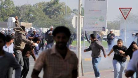 Riot police chase Bahraini demonstrators Monday, Feb. 14, 2011, as they disperse a protest with tear gas in the village of Duraz, Bahrain, outside the capital of Manama. Demonstrations broke out nationwide in response to calls on social media sites for major anti-government protests and were dispersed by riot police firing tear gas and chasing demonstrators. (AP Photo/Hasan Jamali)