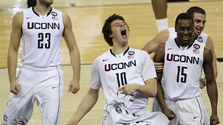 Connecticut players from left, Benjamin Stewart, Tyler Olander, Kemba Walker and Kyle Bailey celebrate after beating Butler 53-41 at the mens NCAA Final Four college basketball championship game Monday, April 4, 2011, in Houston.(AP Photo/Mark Humphrey)