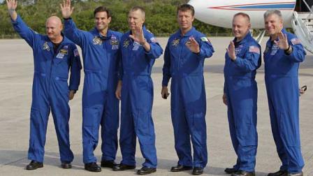 The crew of space shuttle Endeavour, from left, commander Mark Kelly, Canadian born U.S. astronaut Greg Chamitoff, mission specialist Drew Feustel, European Space Agency astronaut Roberto Vittori, of Italy, mission specialist Mike Fincke and British born U.S. astronaut, pilot Greg Johnson, wave to the media after their arrival at the Kennedy Space Center in Cape Canaveral, Fla., Thursday, May 12, 2011. Shuttle Endeavour is due to blast off Monday morning, May 16, 2011 for NASAs next-to-last space shuttle flight. (AP Photo/John Raoux)