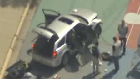 This frame grab from video courtesy KTVI Fox 2/KPLR11 shows authorities surrounding a vehicle on the Missouri University of Science and Technology campus Thursday, May 12, 2011, in Rolla, Mo. Officials say a gunman tried to break into a Missouri Army base and fired on police who pursued him before crashing a vehicle at the university, which went on lockdown after he was seen walking into a campus building. (AP Photo/courtesy KTVI Fox 2/KPLR11)