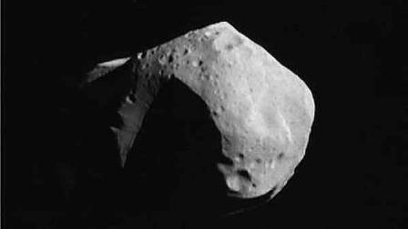 This is an enhanced photo of Asteroid Mathilde taken by the Near Earth Asteroid Rendezvous (NEAR) spacecraft on Friday, June 27, 1997 on a 25-minute flyby. The asteroid is so battered by collisions with outer space rocks that it is almost all crater with one pit big enough to swallow the District of Columbia and some of its suburbs. (AP Photo/NASA,ho)