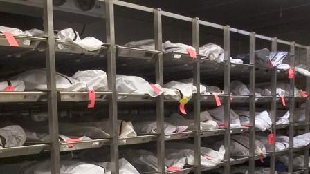 A day after staff put the body into a locked refrigerated
compartment, morgue workers heard someone shouting for help.
(AP Photo/John Miller)