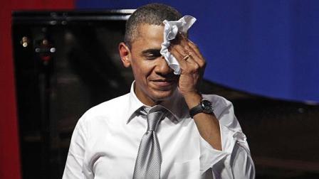 President Barack Obama wipes the sweat from his face after speaks at a fundraiser on the eve of his 50th birthday, Wednesday, Aug. 3, 2011, in Chicago. (AP Photo/M. Spencer Green)