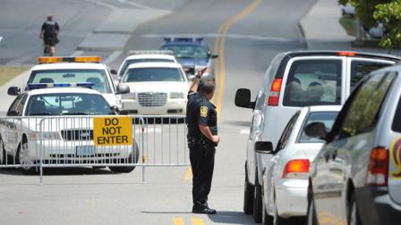 Police stop traffic and shows its presence on the campus of Virginia Tech after a gunman was reported near a Tech drill dining hall at Virginia Tech in Blacksburg, Va, Thursday August 4, 2011. Virginia Tech officials say police officers are searching campus buildings after three children reported seeing a man holding what looked like a gun. (AP Photo/Don Petersen)