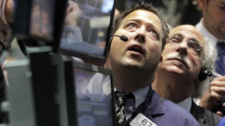 Traders Robert Vella, left, and Peter Tuchman work on the floor of the New York Stock Exchange Thursday, Aug. 11, 2011. (AP Photo/Richard Drew)