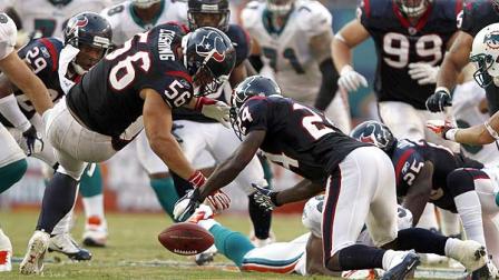 Houston Texans linebacker Brian Cushing (56) and defensive back Brandon Harris (26) go after a fumble by Miami Dolphins running back Daniel Thomas (33) during the second half of an NFL football game, Sunday, Sept. 18, 2011, in Miami. (AP Photo/Hans Deryk)