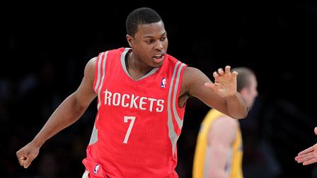 Houston Rockets Kyle Lowry slaps hands with a teammate after making a basket during the first half of an NBA basketball game against the Los Angeles Lakers in Los Angeles, Tuesday, Jan. 3, 2012. (AP Photo/Jae C. Hong)