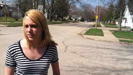 Jordan Pfeiler talks about the mystery booms shes heard over the past few days as she stands outside her house Wednesday, March 21, 2012, in Clintonville, Wis. City officials are trying to record the mysterious booming sounds that have roused residents from their beds, sometimes still in pajamas, but their attempts have so far come up empty. (AP Photo/Carrie Antlfinger)