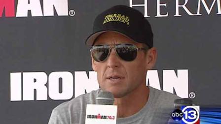 Lance Armstrong speaks to the media in Galveston at an Ironman race