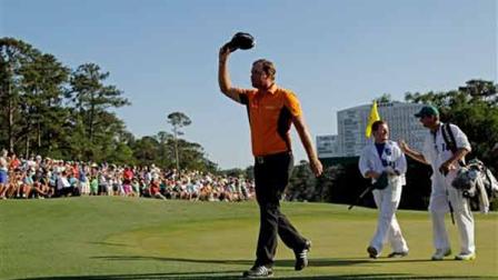 Peter Hanson, of Sweden, salutes the gallery as he walks up to the 18th green during the third round of the Masters golf tournament Saturday, April 7, 2012, in Augusta, Ga. (AP Photo/Charlie Riedel)