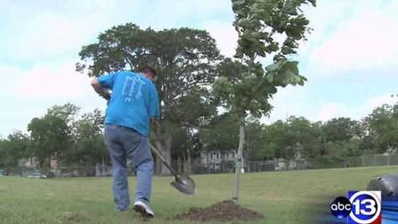 A volunteer plants a tree in Houston ahead of Earth Day