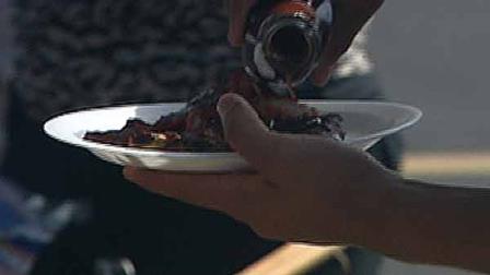 A tailgater prepares a barbecue plate at the Houston Astros first tailgating event