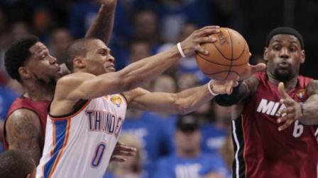 Oklahoma City Thunder point guard Russell Westbrook (0) grabs a rebound as Miami Heat power forward Udonis Haslem (40) and small forward LeBron James defend during the second half at Game 1 of the NBA finals basketball series, Tuesday, June 12, 2012, in Oklahoma City. (AP Photo/Jeff Roberson)