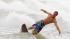 Jesse Deese rides his skim board in the heavy...