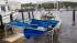 A pleasure boat sits battered and sunken at the...
