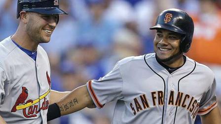 National Leagues Melky Cabrera, right, of the San Francisco Giants, celebrates his two-run home run with Matt Holliday, of the St. Louis Cardinals, during the fourth inning of the MLB All-Star baseball game, Tuesday, July 10, 2012, in Kansas City, Mo. (AP Photo/Jeff Roberson)