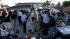 Journalists work in front of the home of the...