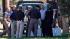 Firefighters and police gather outside the...
